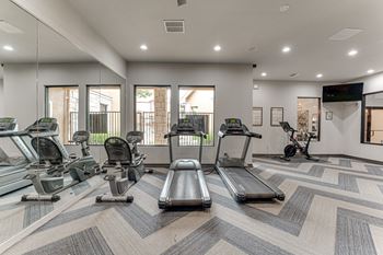 Fitness center with cardio equipment and mirrors
